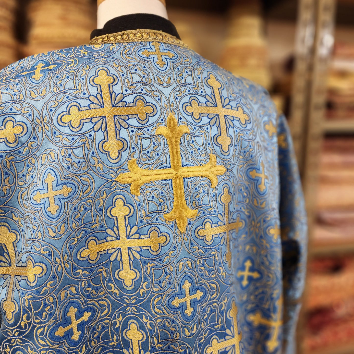Blue fabric with gold cross patterns on a blurred background