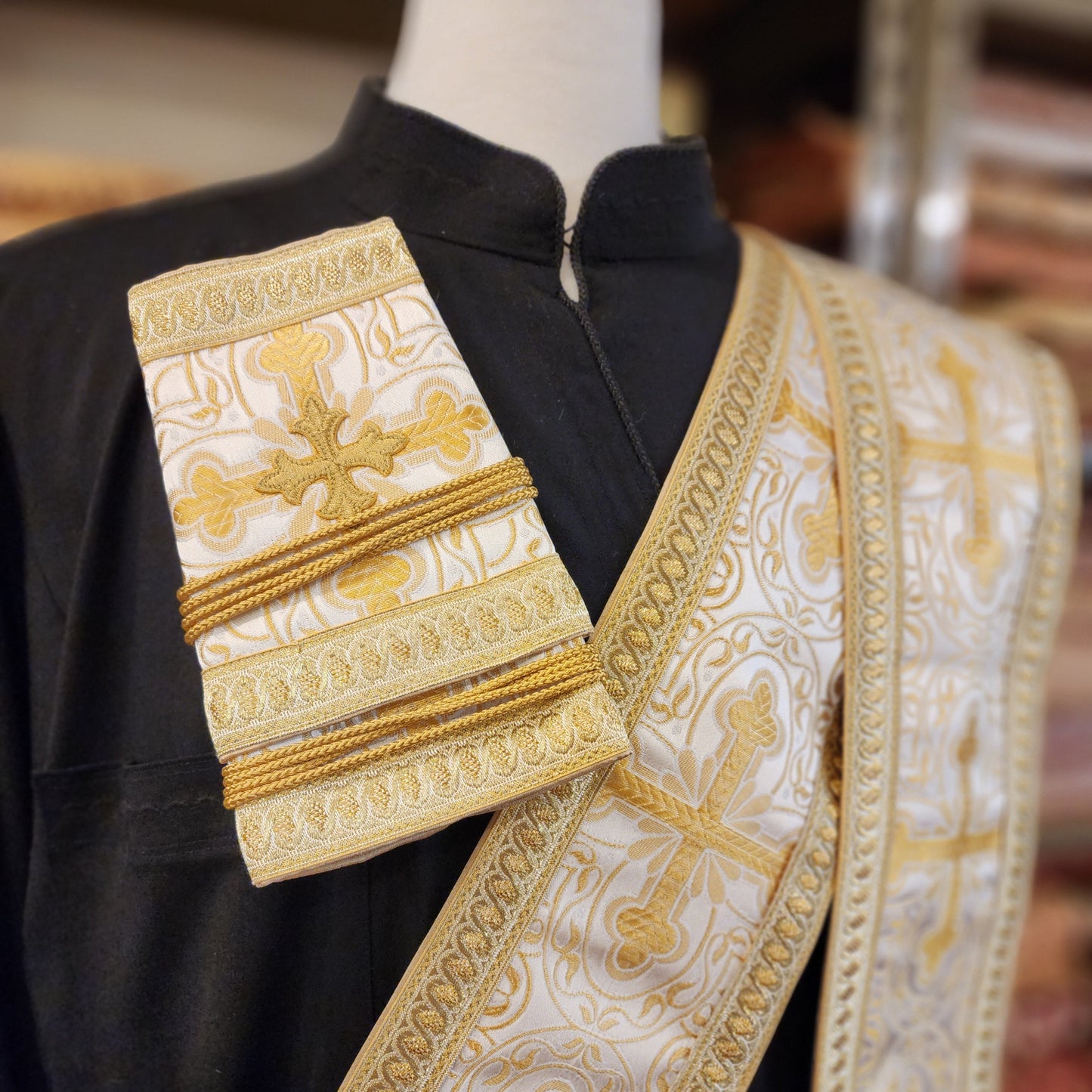 Decorative liturgical vestment with gold embroidery on a blurred background