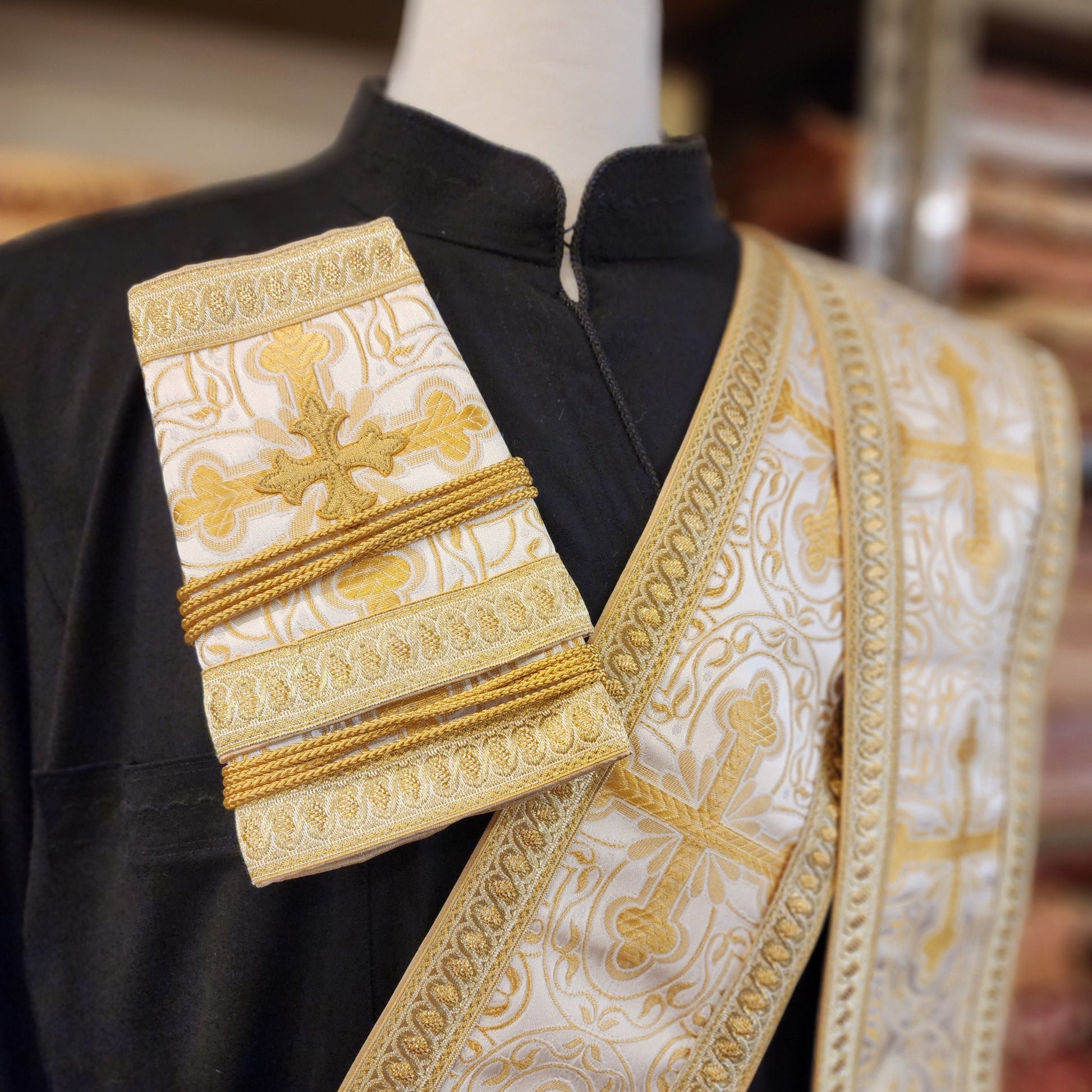 Decorative liturgical vestment with gold embroidery on a blurred background