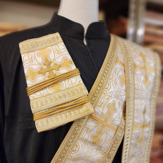 Decorative liturgical vestment with gold embroidery on a blurred background